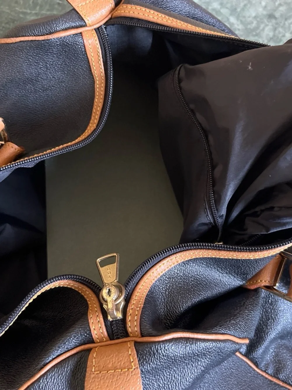Black Leather Duffel Bag with Brown Trim and Olive Pattern Accent
